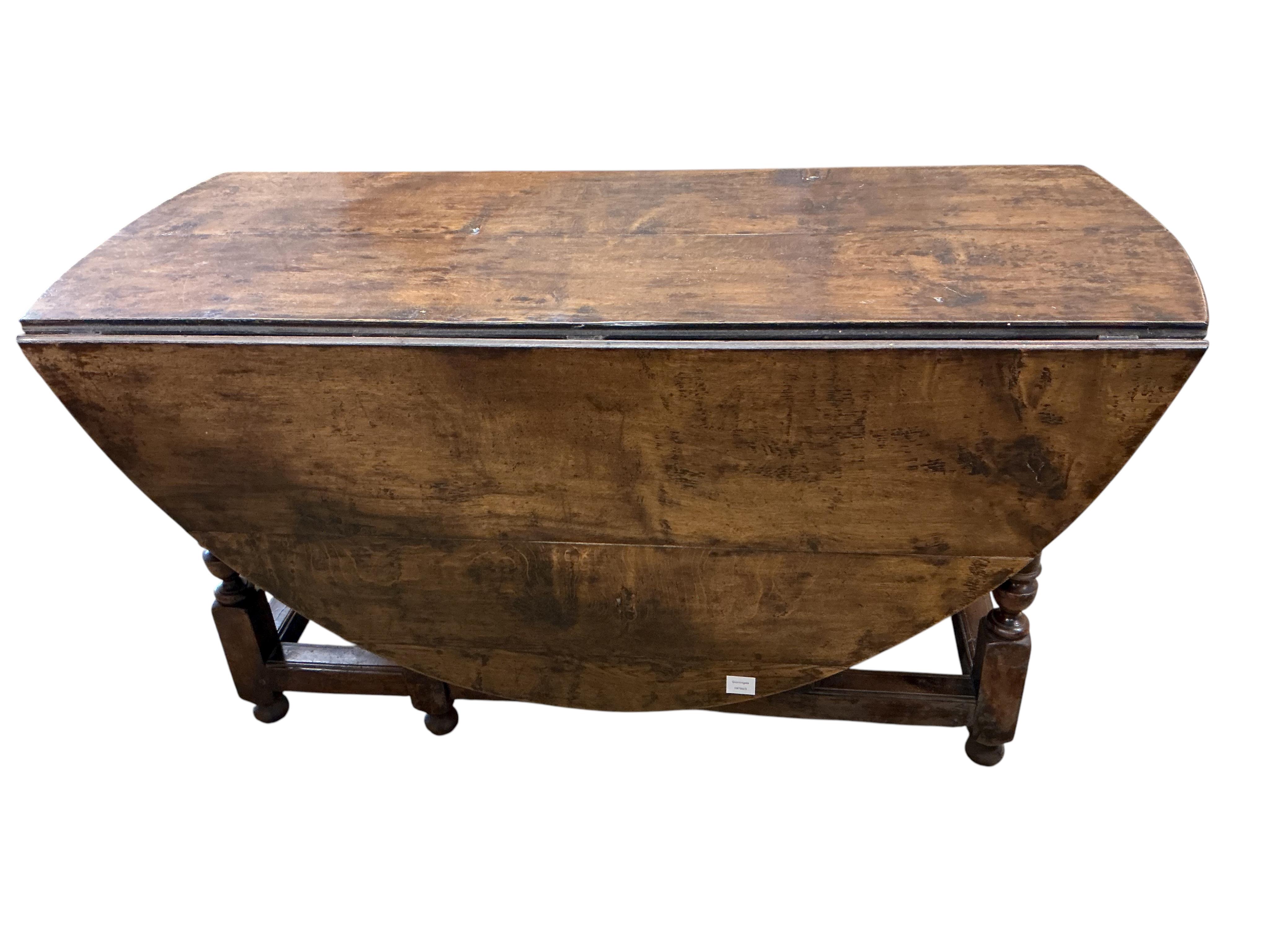 An early 17th century style oak gateleg dining table incorporating earlier elements, width 151cm, depth 62cm, height 75cm